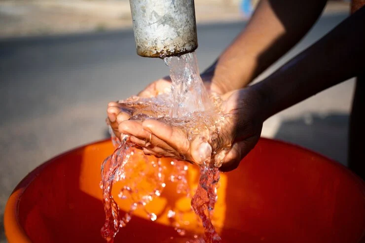 The image of water from a borehole pump in the hero section